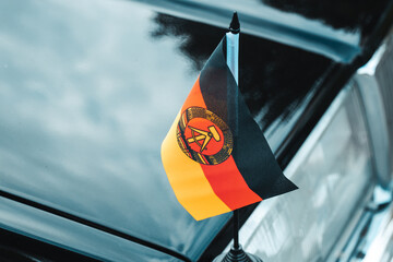 former DDR flag, democratic republic of germany, black car, communist symbols, former eastern bloc