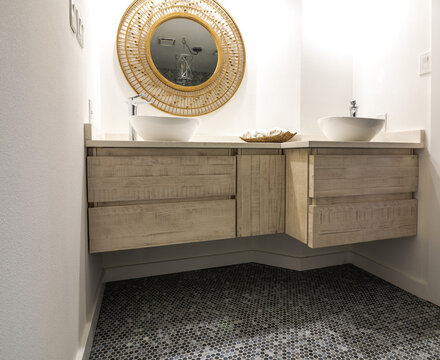 Low view, modern bath interior , with penny tile flooring and natural wood cabinets and accents