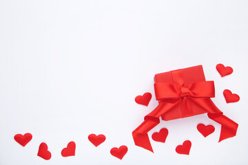 Red gift box with hearts on white background