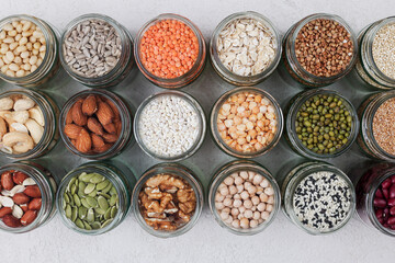 Vegan protein source. assortment of healthy vegetarian food. top view of seeds, nuts, peas, beans, spelt, oatmeal on white background