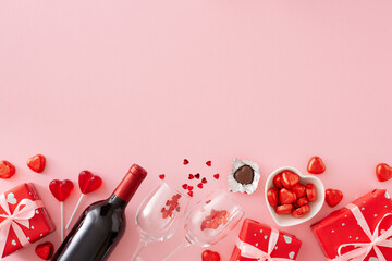 Valentine's Day concept. Top view photo of red gift boxes, wine bottle with glasses, heart shaped...