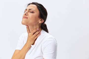 Woman pain throat and back, colds, cold and flu disease, covid-19, in a white t-shirt on a white background