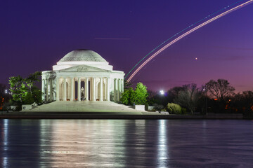 Jefferson Memorial and landing plane light trails  during winter sunset - Washington dc united...
