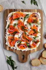 Homemade Cream Cheese Lox Bagel Board with Salmon on a white wooden background, top view. Flat lay, overhead, from above.