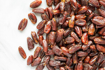 Pitted Organic Dates on gray background, top view. Flat lay, overhead, from above. Space for text.