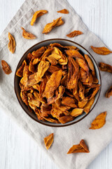 Delicious Organic Dried Mango Fruit in a Bowl, top view. Flat lay, overhead, from above.