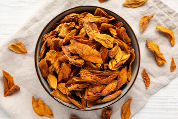 Delicious Organic Dried Mango Fruit in a Bowl, top view. Flat lay, overhead, from above.