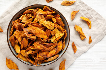 Delicious Organic Dried Mango Fruit in a Bowl, top view. Flat lay, overhead, from above.