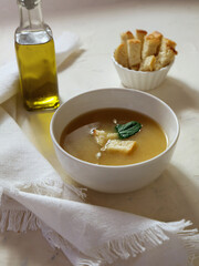 Chicken soup on white kitchen table with bread