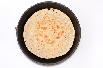 thin latin flatbread tortilla in pan isolated on white background