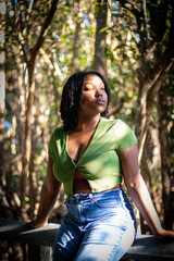 Natural Black woman enjoying her walk in a nature park