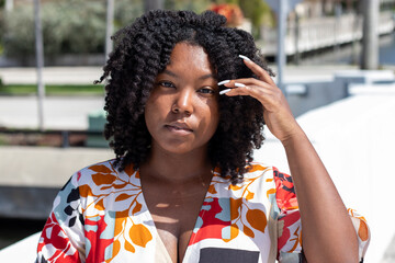 Natural Black Woman basking in the sun enjoying the water.