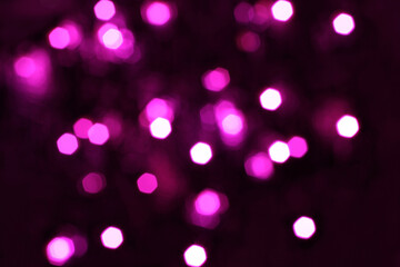 Blurred  white, pink and magenta lights on black background