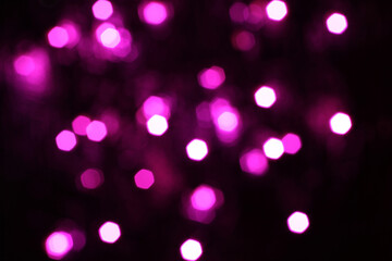 Blurred  white, pink and magenta lights on black background