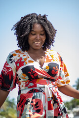 Natural Black Woman basking in the sun enjoying the water.