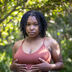 Natural Black woman enjoying her walk in a nature park