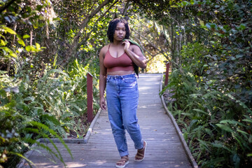 Natural Black woman enjoying her walk in a nature park