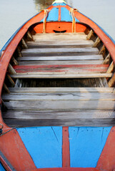 Fototapeta na wymiar A wooden colourful traditional boat at the coastline of Ko Lipe Island in Thailand
