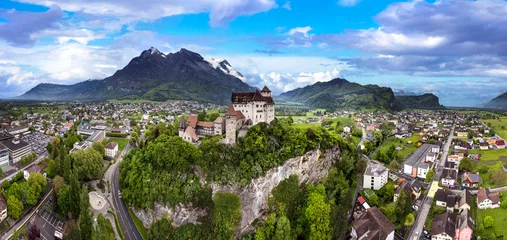 Poster beautiful medieval castles of Europe - impressive Gutenberg in Liechtenstein, border with Switzerland, surrounded by Alps mountains, aerial view © Freesurf