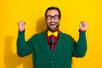 Naklejka premium Photo portrait of young nice guy spectacles palm raise fists excited lottery wear trendy green outfit isolated on yellow color background