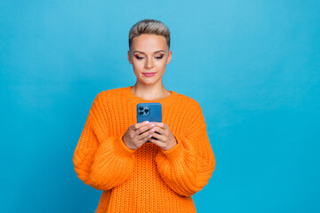 Photo of charming pretty lady wear orange sweatshirt chatting twitter telegram facebook isolated...
