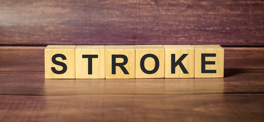 stroke word made with wooden blocks and brown background