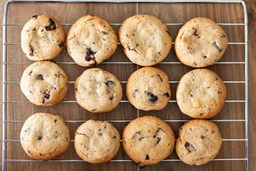 High angle close up of baking tray with freshly baked chocolate chip cookies