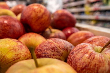red apples in a close-up are sold in a shopping center in the department of vegetables and fruits