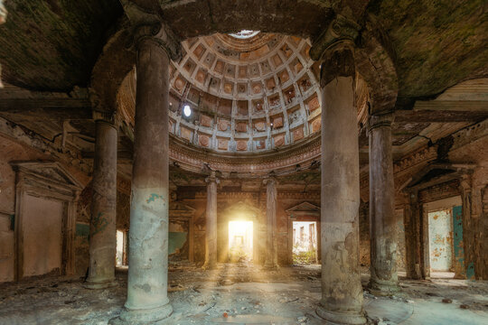 Interior of old ruined palace with columns and dome