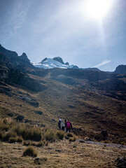 Fototapeta premium tourists walking towards the glacier on a mountain, in peru south america