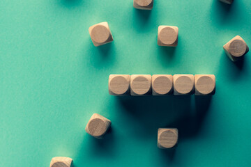 Five wood cubes are placed on a black background. Material for composing text.
