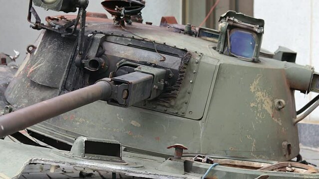 War in Ukraine. Destroyed tank with a torn off turret with a V on it. Broken and burned Russian tanks. Designation sign or symbol in white paint on the tank. Destroyed military equipment.