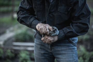 man wipes dirty hands with a rag