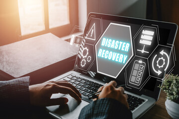 Disaster Recovery concept, Person hand using laptop computer with Disaster Recovery icon on virtual screen.