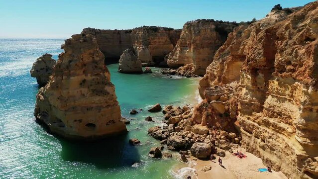 Beach in Algar Seco Benagil Algarve Portugal. Coast cliffs and beach aerial drone view