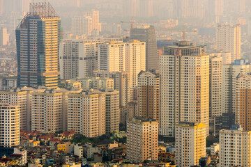 Fototapeta na wymiar Elevated view of golden light on high rise apartment towers at Hanoi in Vietnam