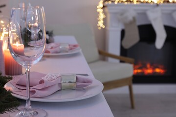 Beautiful festive place setting with Christmas decor on table indoors, space for text