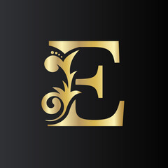 Golden Initial Letter E with simple floral leaves. Luxury Natural Logo Icon. Elegant botanic design Vector illustration