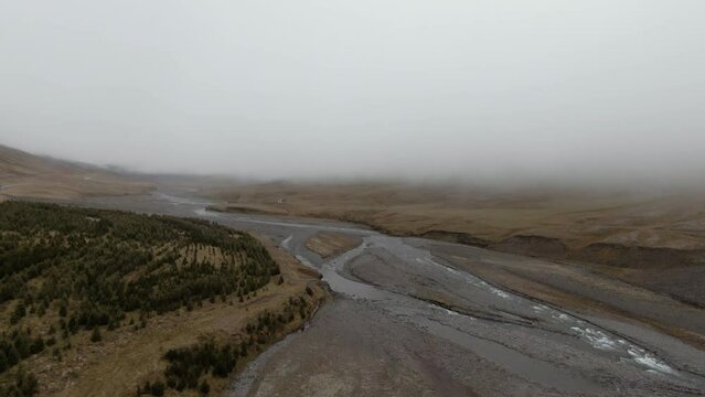 Thick fog layer above river in rural desolate countryside