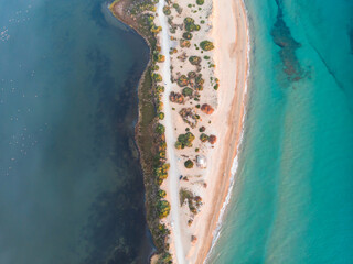 Beautiful aerial vibrant view of Korission Lake Lagoon landscape, Corfu island, Greece with pink flamingos flock, Ionian sea beach and mountains in a summer sunny day