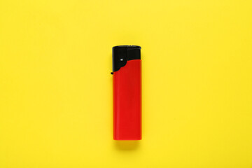 Obraz premium Stylish small pocket lighter on yellow background, top view