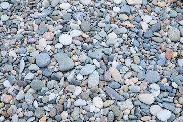 Surface covered with many different pebbles as background