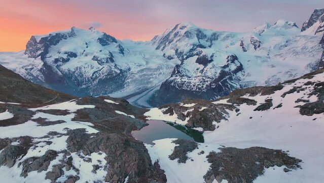 idyllic sunrise in Swiss Alps, beautiful aerial view of snowy glacier in European Alps ,the famous five lakes of Matterhorn and Gornergrat ridge