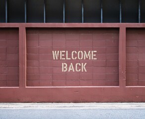 Brown wall in city with text inscription WELCOME BACK, concept of business re-opening again after renovation or pandemic lock down, welcome back greeting to customers, visitors or travelers
