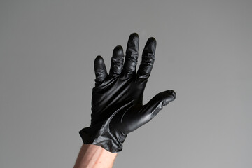 human palm wearing black latex glove isolated