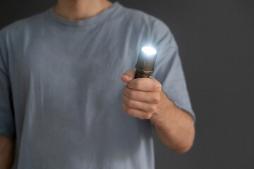man holding an electric light torch in the dark space