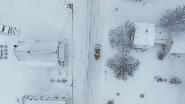 Snowplow clearing road through Monson Town