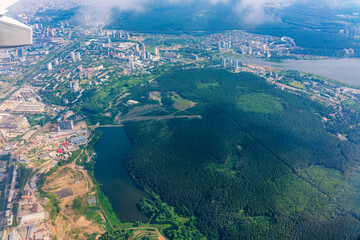 View from the airplane window during taking off on a clear summer morning. Yekaterinburg, Russia