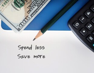 Dollars cash money and calculator with pencil writing SPEND LESS SAVE MORE, financial planning to...