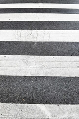 crosswalk on the road for safety when people walking cross the street.